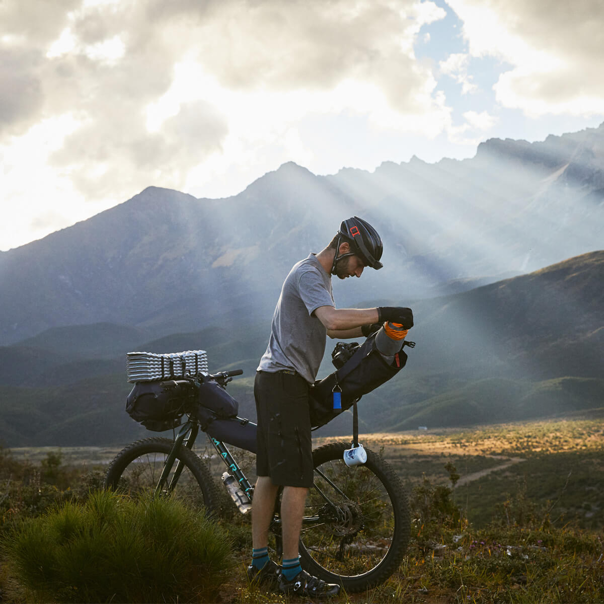Off-Road Seat Pack Large with tapered design for easy access, featuring M.O.L.L.E. attachment system, durable waterproof fabric, and a stable adjustable rack for secure fitting.