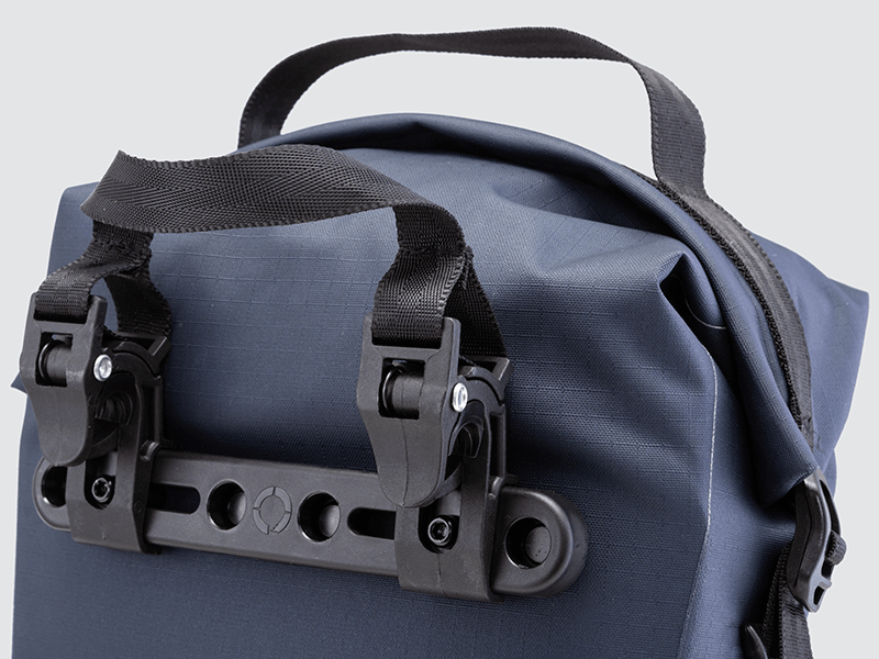 Waterproof Tour pannier bags (20L pair) with quick-tighten closure and reflective details for long-distance touring.