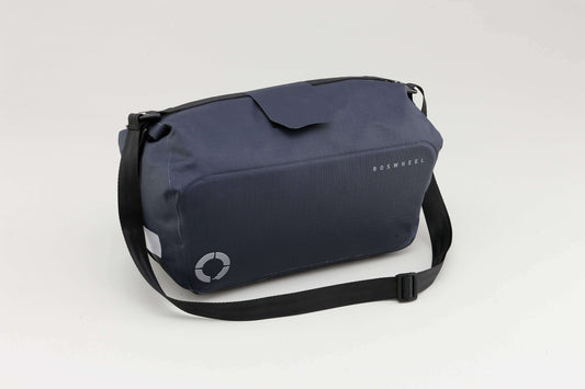 Waterproof Tour trunk bag with integrated attachment, reflective details, and protective base for secure storage.