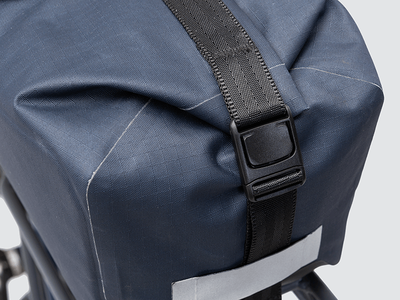 Waterproof Tour trunk bag with integrated attachment, reflective details, and protective base for secure storage.