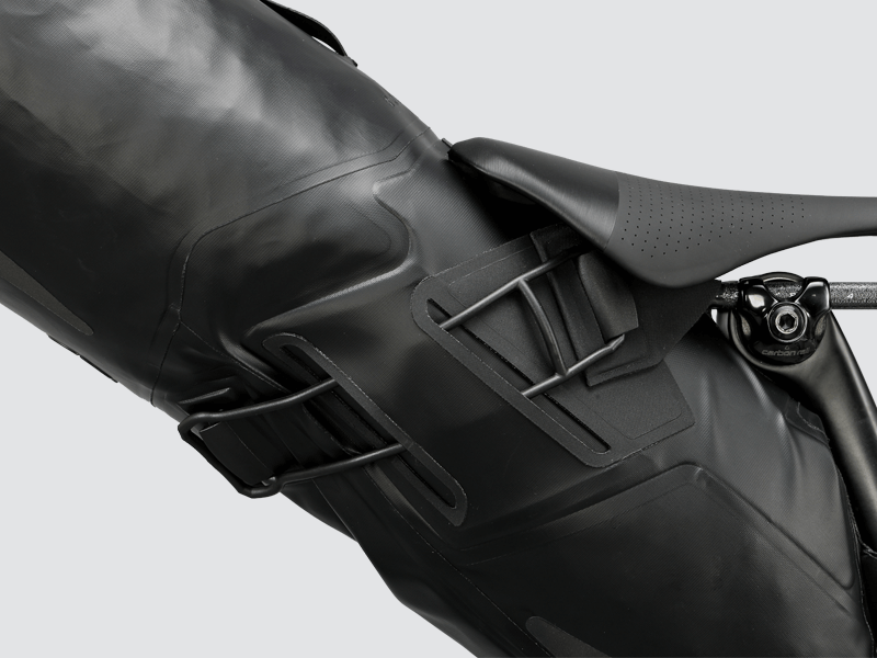 Road Seat Pack Medium designed for convenience and secure attachment, featuring 'Fast-Fix' strap system, lightweight construction, and large reflective areas for enhanced visibility.