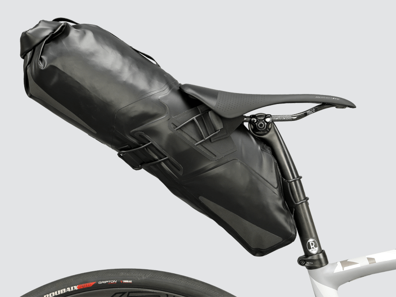 Road Seat Pack Medium designed for convenience and secure attachment, featuring 'Fast-Fix' strap system, lightweight construction, and large reflective areas for enhanced visibility.