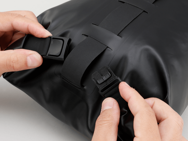 Road Seat Pack Small designed for fast rides, featuring 'Fast-Fix' strap system for secure attachment, lightweight construction, and large reflective areas for visibility.