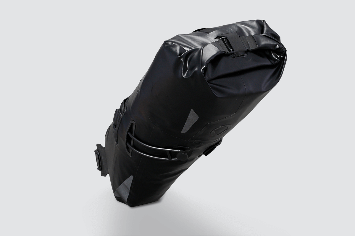 Road Seat Pack Small designed for fast rides, featuring 'Fast-Fix' strap system for secure attachment, lightweight construction, and large reflective areas for visibility.