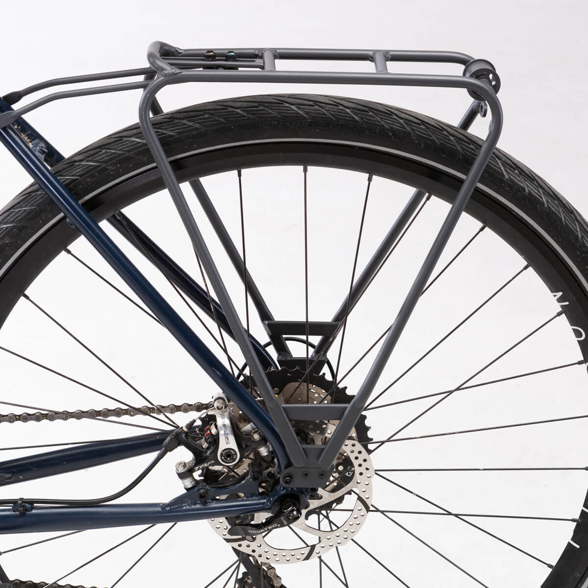 Tour Lightweight Rear Rack for touring and city use, compatible with pannier bags and disc brake bikes.