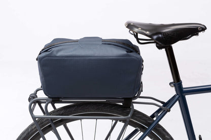 Waterproof Tour trunk bag with integrated attachment, reflective details, and protective base for secure storage.