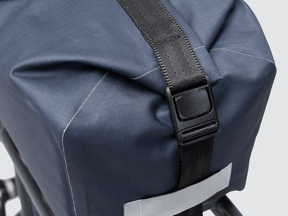 Waterproof Tour trunk bag with integrated attachment, reflective details, and protective base for secure storage.